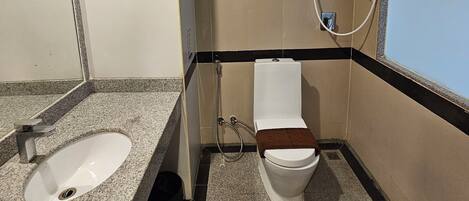 A bathroom with a sink, toilet, and shower.