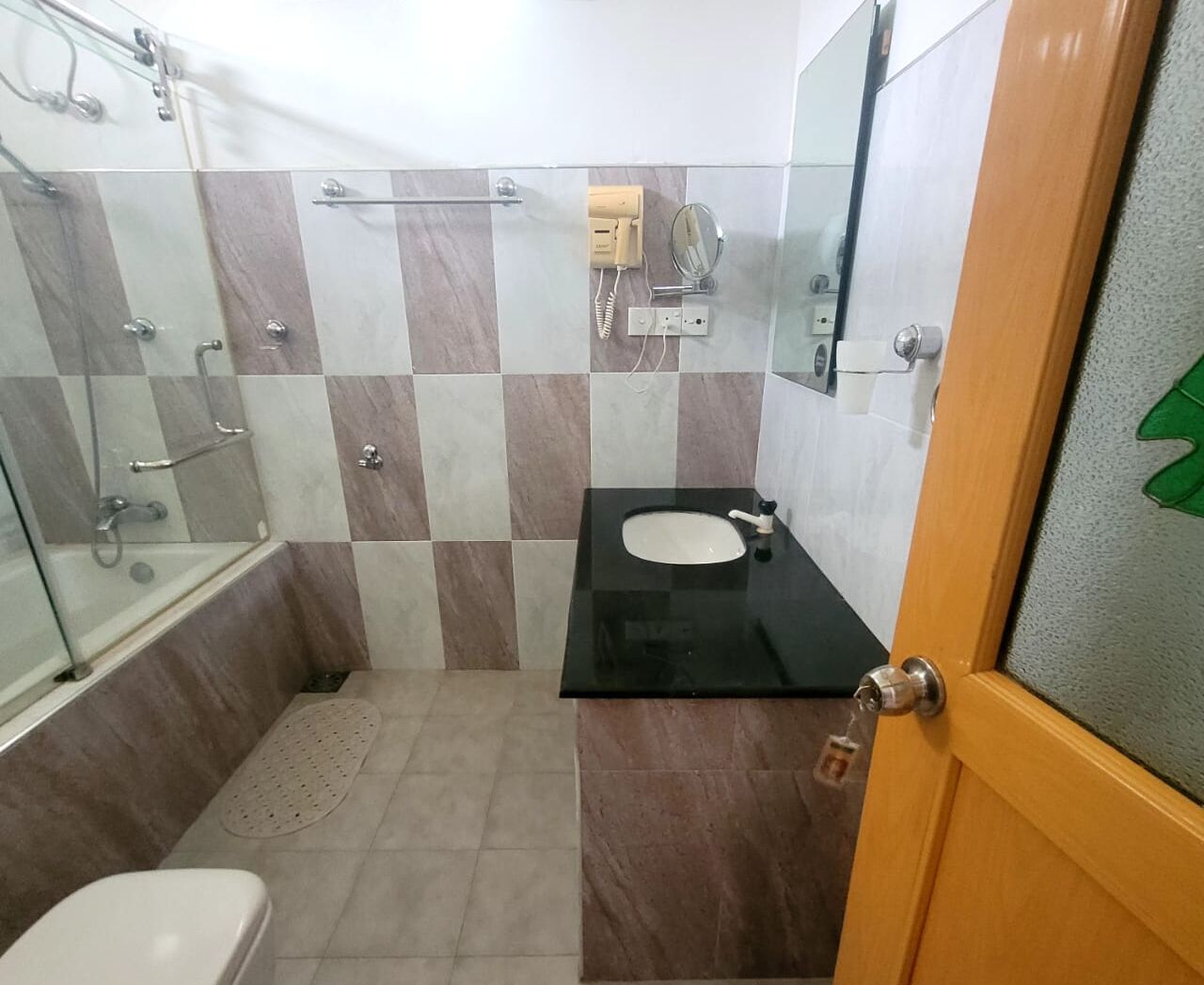 A bathroom with a bathtub, a sink, and a toilet.