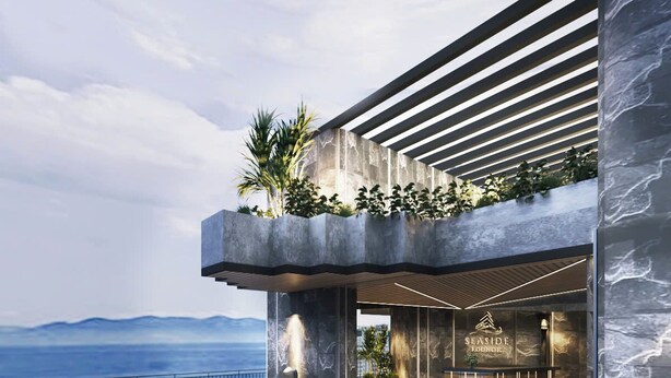 A modern seaside lounge with a pool area, seating, and a view of the ocean. - Seaside Boutique Hotel Nha Trang Beach (Nha Trang)
