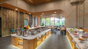 A modern restaurant with a central buffet area, wooden accents, and a view of greenery outside. - Seaside Boutique Hotel Nha Trang Beach (Nha Trang)