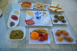 A table with various food items including bread, cheese, eggs, and fruits. - Royal Cairo Hotel (Cairo)