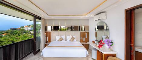 A modern bedroom with a large bed, a desk, and a view of a lush landscape.
