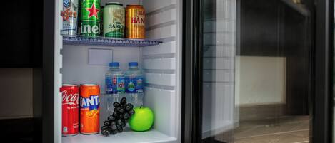 A refrigerator stocked with beverages and fruits.