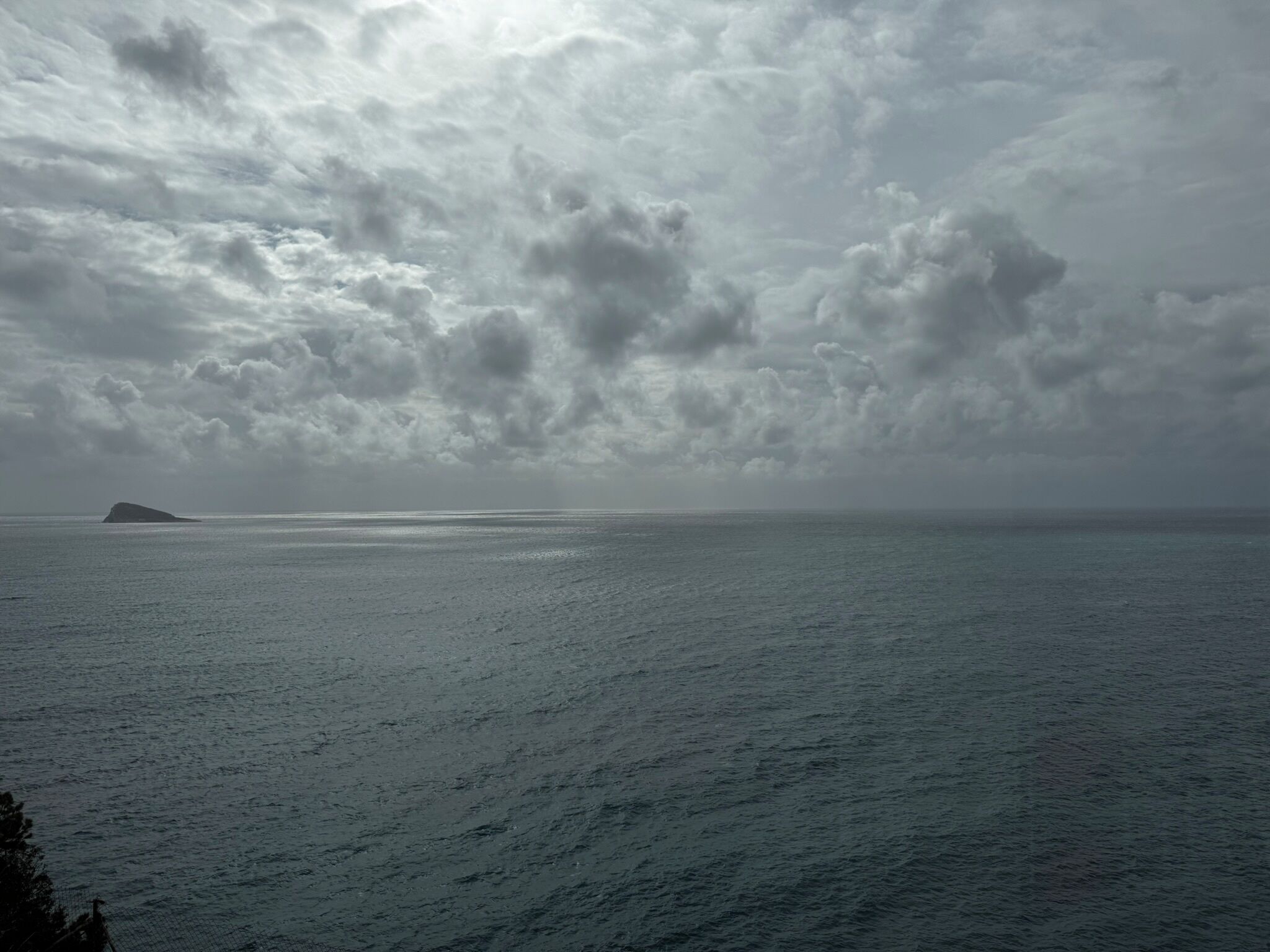 A coastal view with a body of water and a distant island.