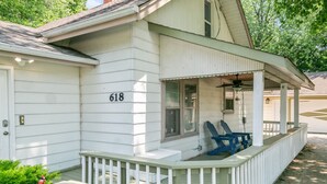 A white house with the number 618, a covered porch, and two blue chairs. - 5 Bed Home w/ Big Yard & Front Porch by Navy Base (Libertyville)