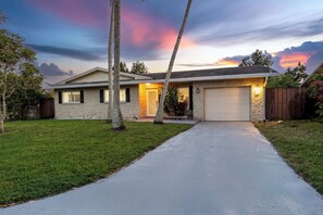 A single-story house with a garage, a well-maintained lawn, and a driveway leading to the entrance.