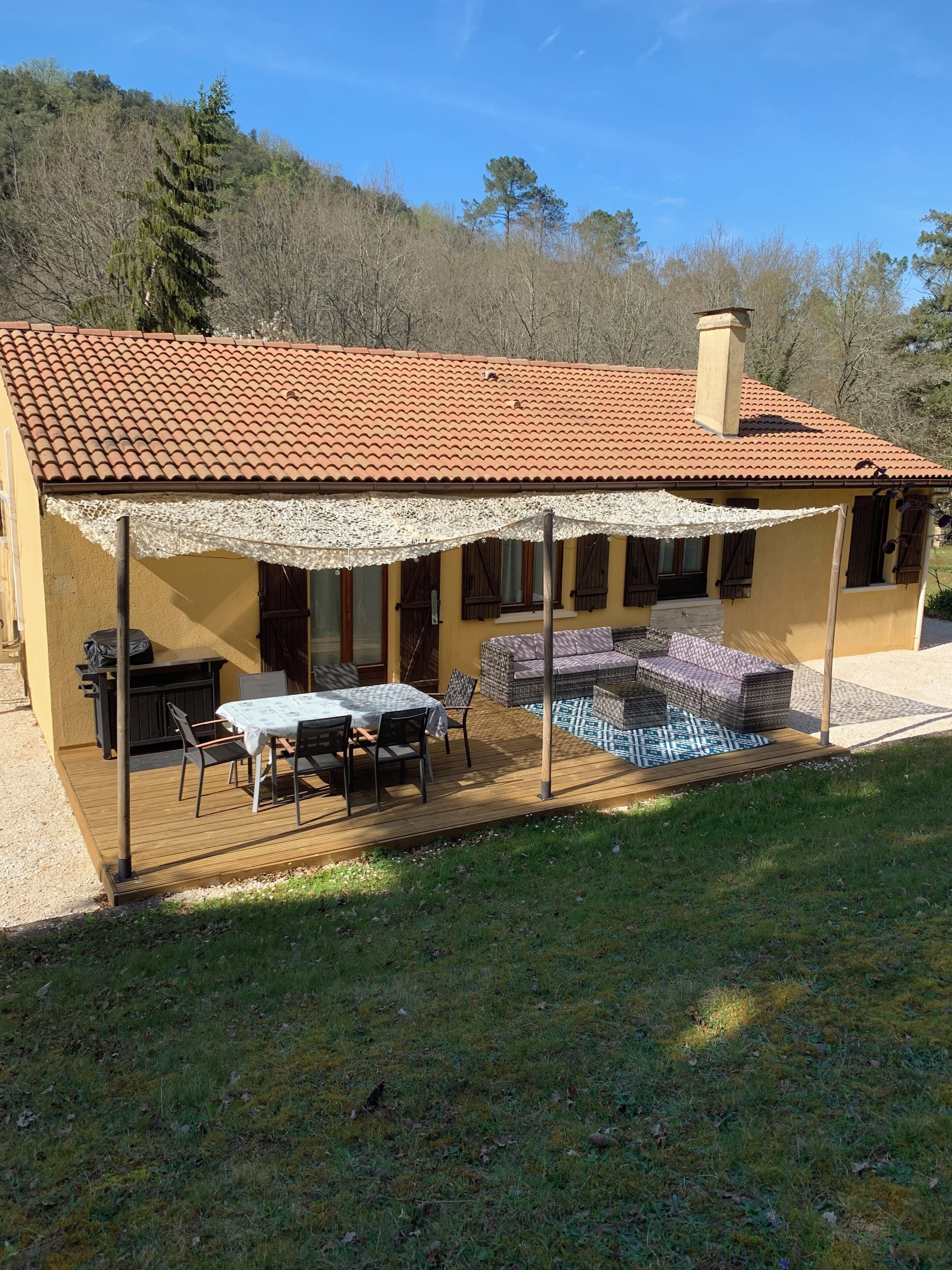 A house with a patio, outdoor furniture, and a covered area.