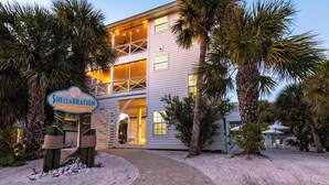 A two-story building with a sign reading "Shellabratation North Captiva Island." - Shellabration: Ocean Views, Heated Pool, Basketball, Golf Cart (North Captiva)