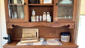 A wooden dresser with multiple drawers and a glass-fronted cabinet containing various items. - Peaceful, Private 1-bedroom campground in Vandalia (Vandalia)