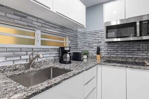 Fridge, microwave, stovetop, coffee/tea maker