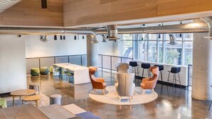 A spacious, modern office with a large open area, a conference table, and several seating arrangements.