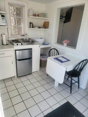 Enjoy cooking in this well-equipped kitchen with a stove, sink, and refrigerator.