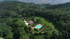 A large, secluded property with a swimming pool, surrounded by dense forest, and a view of distant hills. - Podere La Marroneta (Tuscany Hills & private Pool) (Rivalto)