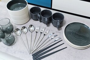A kitchen counter with various utensils, including spoons, forks, and knives, and several cups and a bowl. - GRANQUAL Horikiri by Tranova (Tokyo)