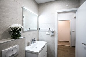Shower, hair dryer, slippers, towels