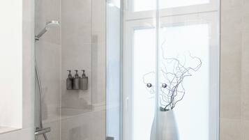 Shower, hair dryer, towels, toilet paper