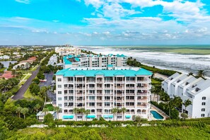 A multi-story hotel with a pool, located near a beach with ocean views. - LUXURY 4-Ensuites Beach condo in Jupiter 100 Yards to Ocean!Ocean Views! (Jupiter)