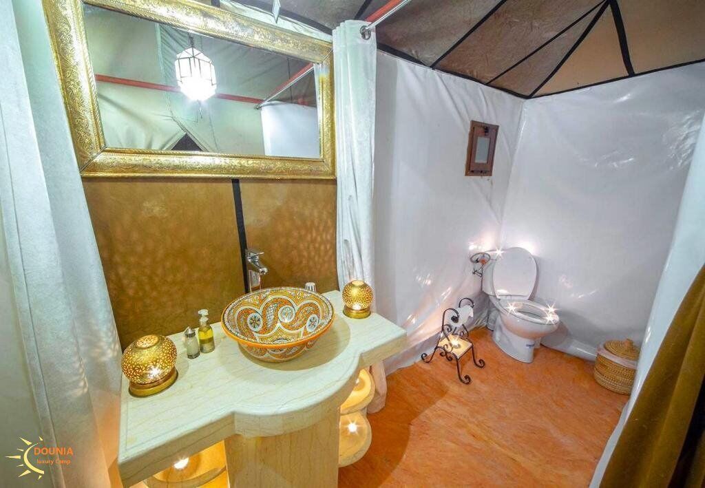 A bathroom with a vanity, sink, and toilet.