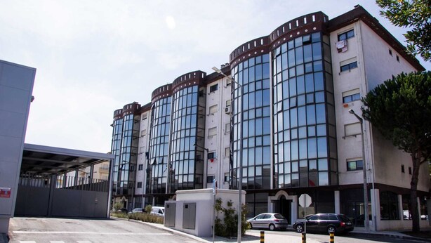 A multi-story building with large windows and a modern design.