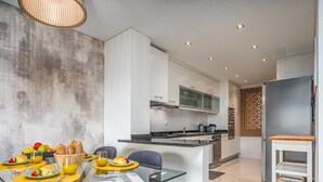 A modern kitchen with a dining area.