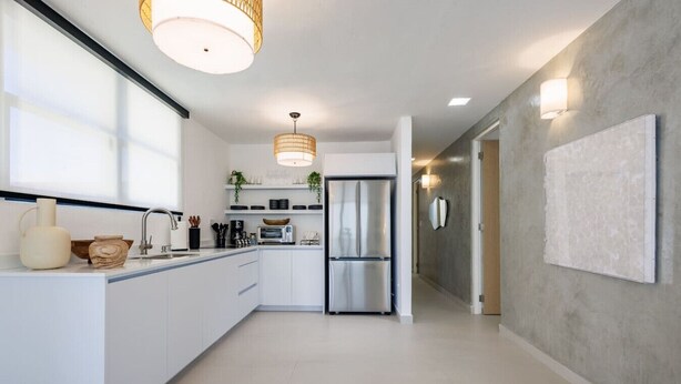 A modern kitchen with white cabinetry, stainless steel appliances, and pendant lighting. - Modern & Spacious Retreat in Hato Rey | Unit 2 (San Juan)