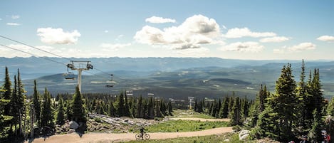A mountain biking trail with a ski lift in the background.