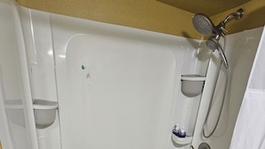 A white bathtub with a showerhead, a handheld showerhead, and a handheld showerhead. - Charming lodge in delightful Kelso with AC, WiFi (Kelso)
