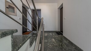 A modern interior with a marble staircase, metal handrails, and a minimalist design. - Amazing apartment in Novalja with WiFi (Novalja)