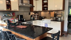 A modern kitchen with a central island, built-in appliances, and ample storage cabinets.