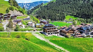 A mountain village with traditional wooden houses, a ski lift, and a green valley. - Mountain Suite Nr 301 by Interhome (Grossarl)