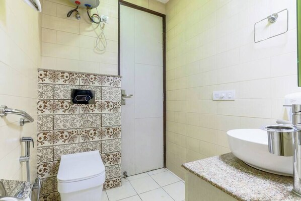 Un baño con inodoro, lavamanos y ducha.