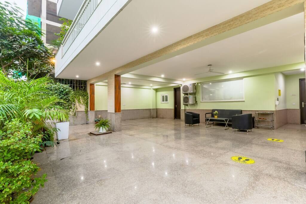 A spacious indoor area with a polished floor, seating arrangements, and a reception desk.