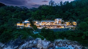 A large, multi-story resort with multiple buildings, a pool, and a view of the ocean. - The Aquila Villa  (Kamala)