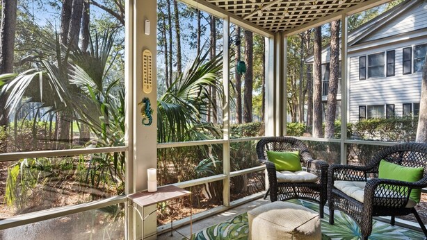 A covered outdoor area with wicker furniture, a seahorse decoration, and a thermometer. - 55-2 Low Country Get-a-way 2 Bedroom Condo (Pawleys Island)