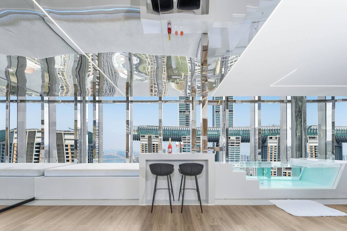 A modern kitchen with a large window overlooking a cityscape.