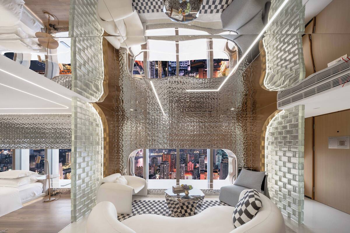 A modern interior with a city view, checkered floor, and a mix of white and grey furnishings.