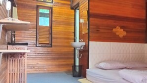 A wooden cabin room with a bed, a sink, and a window. - Murai Pagi Homestay (Harau)