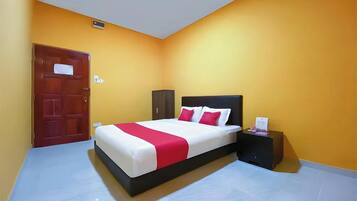 A bedroom with a bed, nightstand, and a door.