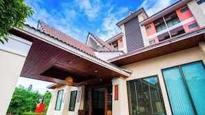 A modern two-story building with a covered entrance and large windows. - Good View Residence (Lampang)