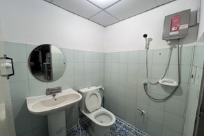 A small bathroom with a sink, toilet, and shower. - Green Place 107 (Bangkok)