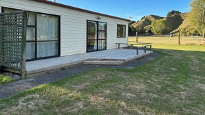A single-story building with large windows and a covered patio area. - Alpaca Farm Cottage (Ongarue)