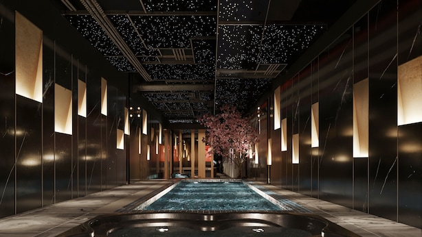 Un espace spa doté d’un grand jacuzzi central, de lambris en bois et d’un plafond décoré de motifs étoilés.