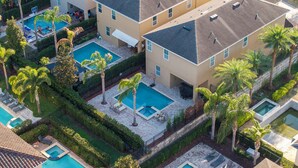 A residential complex with multiple swimming pools, palm trees, and a basketball court. - Classic 8-bedroom house with AC, WiFi in Kissimmee - Encore Reunion (Kissimmee)