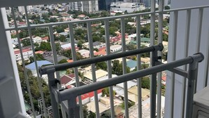 A balcony with a metal railing overlooking a cityscape with various buildings and greenery. - Property near to Trident,Ayala,BGC and Airport and Supermarket & restaurant (Makati)