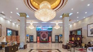 A spacious lobby with a large chandelier, a reception desk, and a digital screen displaying information. - Fuzhou Rongtong Meifeng Hotel (Fuzhou)