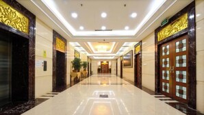 A hotel lobby with a polished marble floor, ornate gold detailing on the walls, and a central chandelier. - Fuzhou Rongtong Meifeng Hotel (Fuzhou)