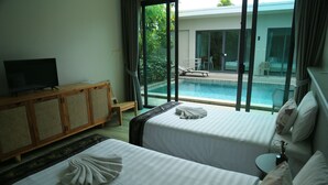 A hotel room with two beds, a TV, a wooden cabinet, and a view of an outdoor swimming pool. - Beautiful 4 Bedroom Private Pool Villa in Laguna Bangtao, Daily Cleaning (Tambon Choeng Thale)