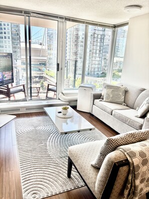 A modern living room with a sofa, coffee table, and a TV.