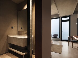 A modern bathroom with a large mirror, a built-in sink, and a view of the sea through large windows. - Qingdao Innland sea-view designer (Qingdao)