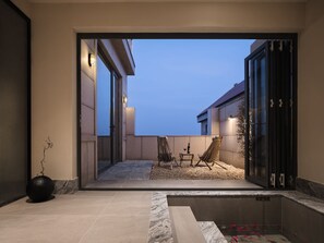 A modern outdoor patio with a pool, seating area, and a view of the sky. - Qingdao Innland sea-view designer (Qingdao)